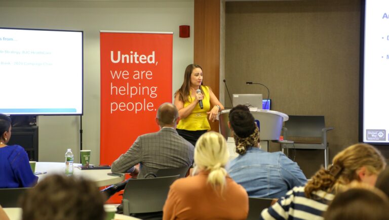 United Way Campaign Vice-Chair, SiSi Beltran, speaks in front of a group