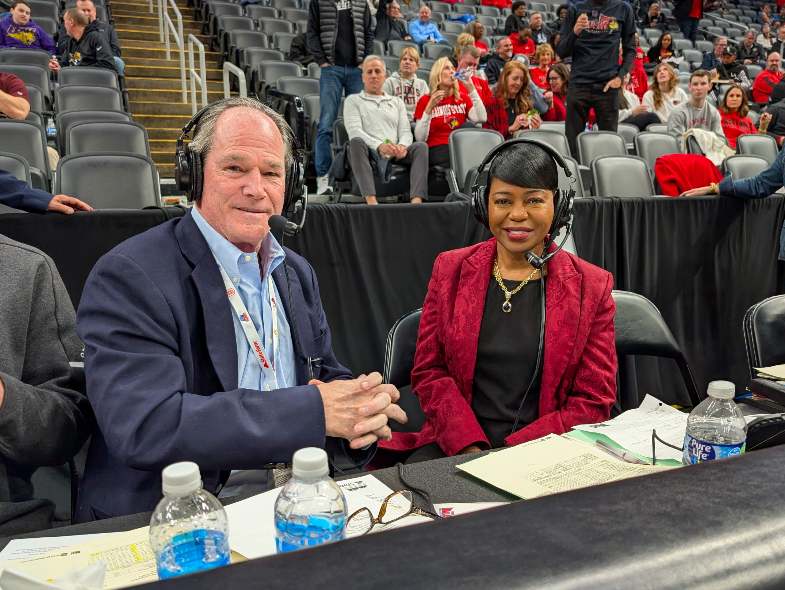 Michelle Tucker sits in the announcer both during Arch Madness